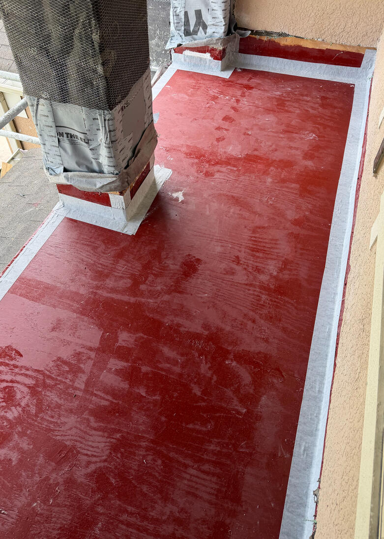 This foundational stage establishes a moisture-resistant base using a penetrating epoxy primer. The substrate is reinforced with polymeric rubberized tape and elastomeric sealant to secure all joints prior to the final coating.