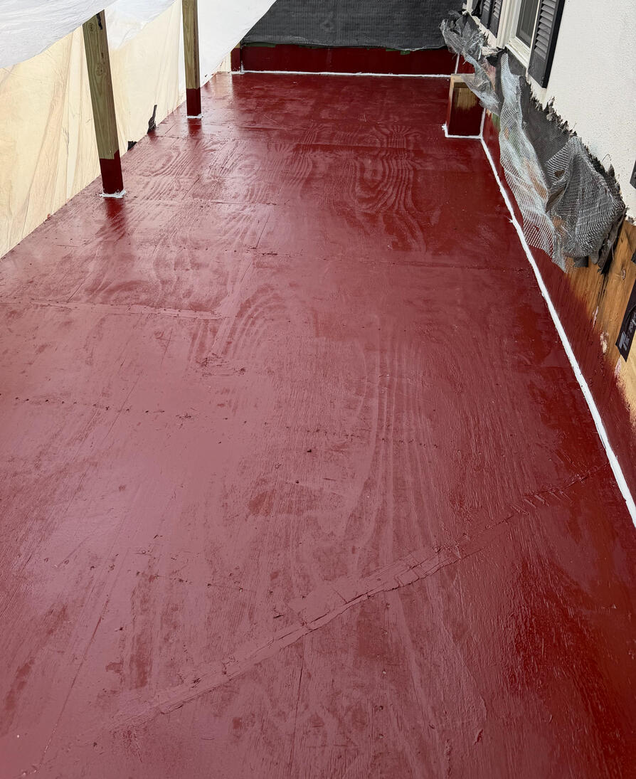 The substrate is primed with a high-performance epoxy to seal porosity and ensure coating bond. We utilize an industrial elastomeric sealant at all critical junctions to prepare the surface for the waterproofing membrane.